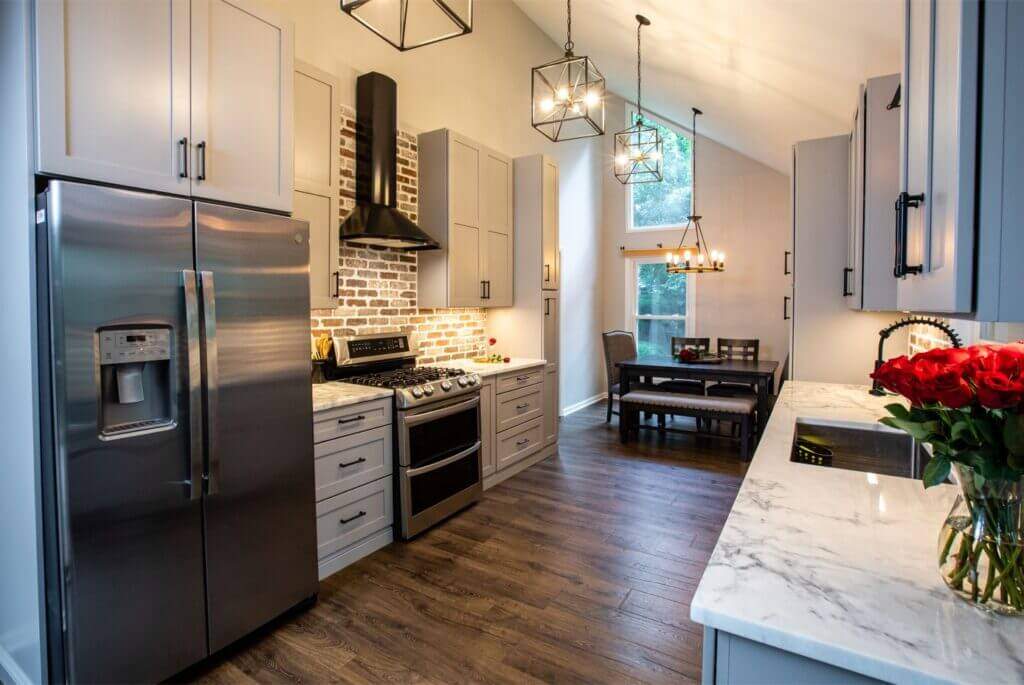 small kitchen with white cabinets and dining area