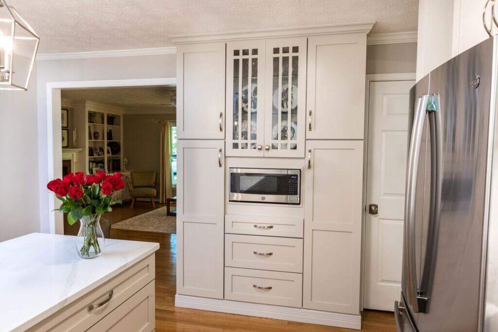 tall white storage cabinet with built in microwave