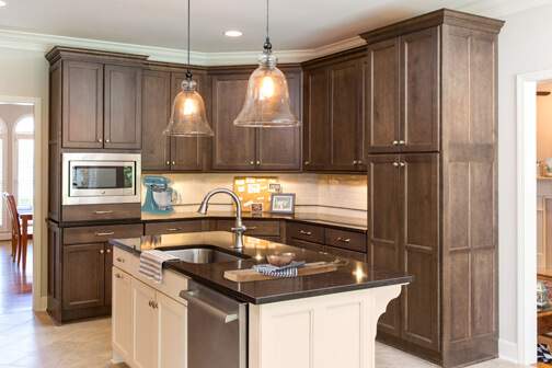dark stained kitchen cabinets with white kitchen island