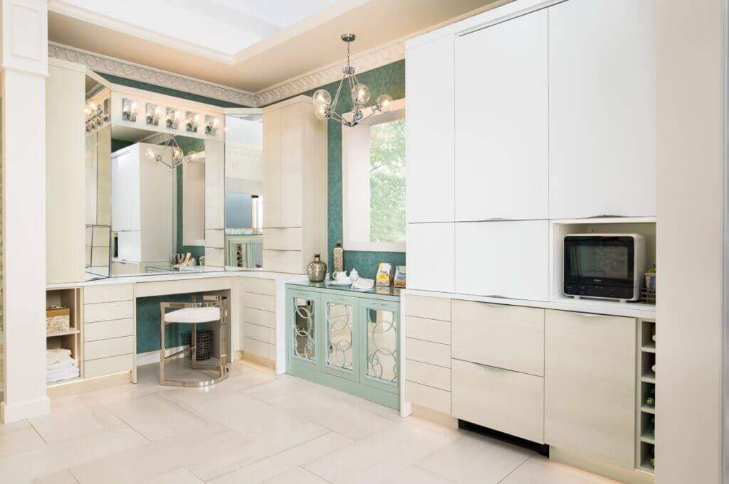 bathroom design with white cabinets, mint color pop, and seated vanity
