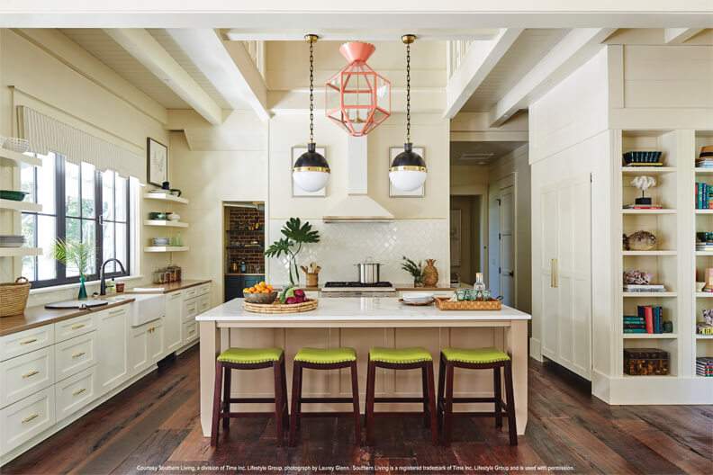 white kitchen with large island with green barstools 